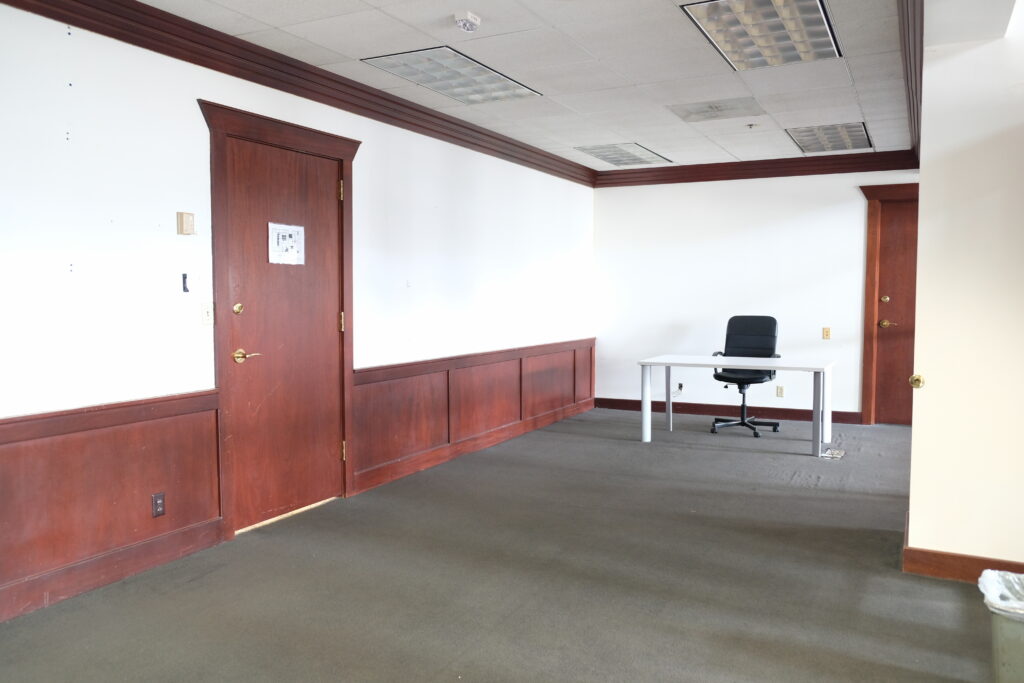 Large office space with desk and chair.
